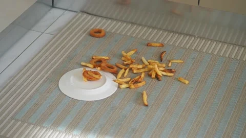 Fries and donuts fall on the kitchen floor Stock Footage 337446746