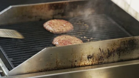 Fries are Boiling While Man is Lifting Meat on a Grill Stock Footage 71557666