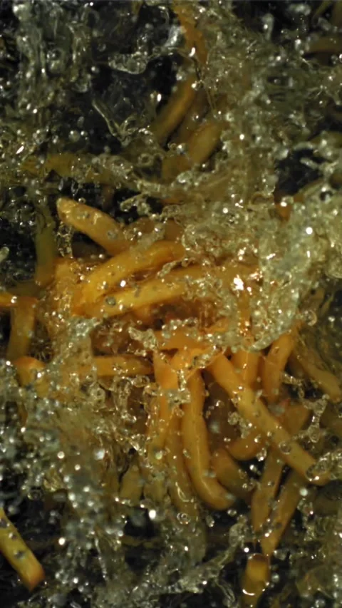 The fries fall into the hot oil. Filmed on a high-speed camera at 1000 fps Stock Footage 335315331