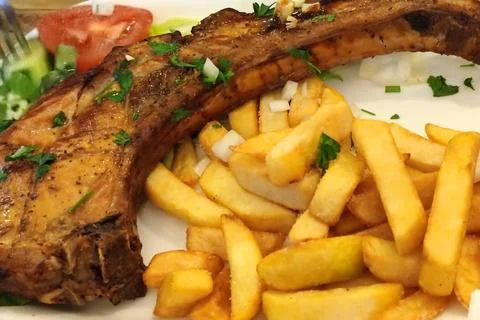 Fries with fried pork on the bone Stock Photos