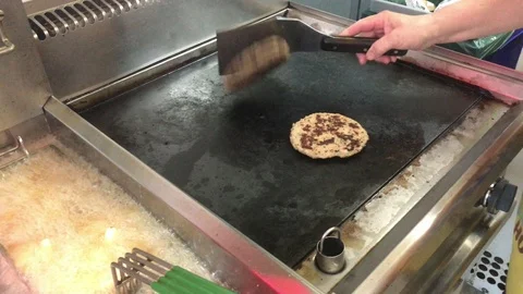 Fries on Fry Machine vs Flipping the Burger on The Grill. Burgers on The Grill Stock-Footage 92184202