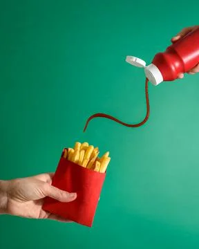 Fries potatoes in package in hand Stock Photos