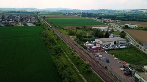 Fright train passing landscape and small village Stock Footage 108590108