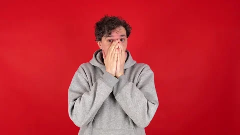 Frightened, anxious man covers face hands, looks through fingers, shakes head Stock Footage 304748616