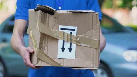 Frightened delivery worker giving broken customer parcel, shipment accident Stock Footage 91240634