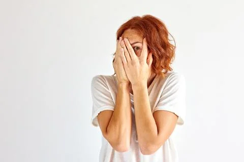 Frightened female close her face by fear Stock Photos
