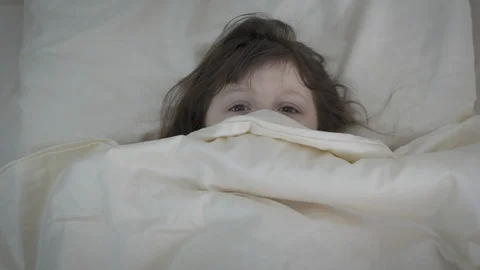 Frightened kid under the covers. Stock Footage 116830152
