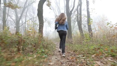 A frightened little child is running through the foggy deserted forest. Stock Footage 81320175