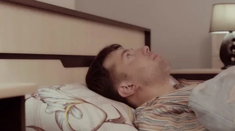 Frightened man hears something strange and hides under the blanket Видео 68421316