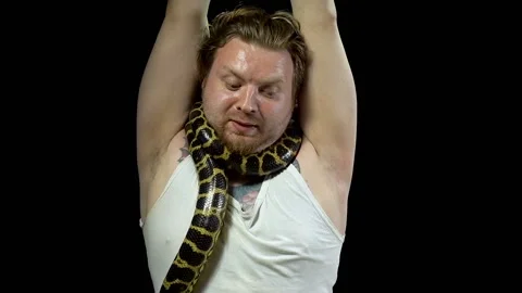 Frightened man with python on his neck Stockbeeldmateriaal 94980407