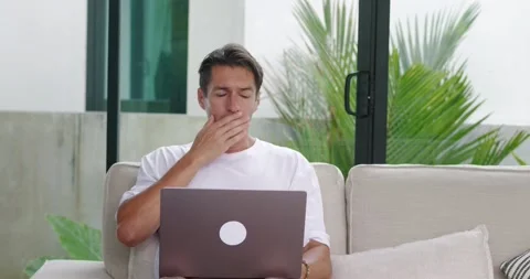 Frightened man sees something terrible on laptop screen in horror takes off his Stock Footage 237904515