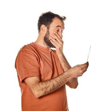 Frightened man before taking an antigen test, covering his mouth with his han Stock Photos