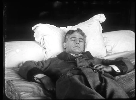 Frightened man watching another man sleep on pillow, United Kingdom, 1923 Video stock 172219381