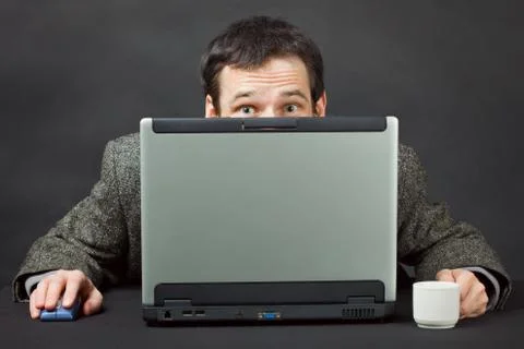 Frightened people hiding behind computer screen Stock Photos