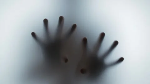 Frightening shadow of hands creeping down a frosted glass Stock Footage 327158470