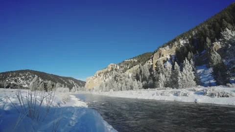 Frigid Winter Creek Flows Through Snowy Valley Stock Footage 301013663