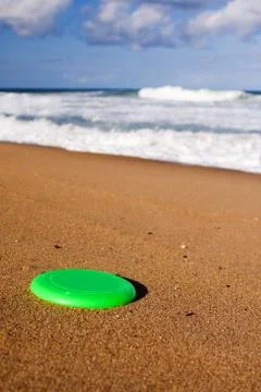 A frisbee on the beach sand Stock Photos