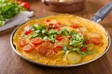 Frittata with tomatoes, herbs and chilli Stock Photos