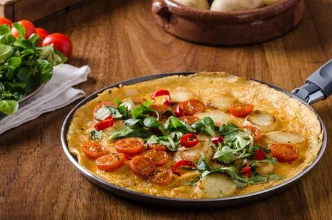 Frittata with tomatoes, herbs and chilli Stock Photos
