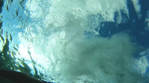 Frog eye view man dives in the depths of the sea with snorkel with blue sky Stock Footage 296203004