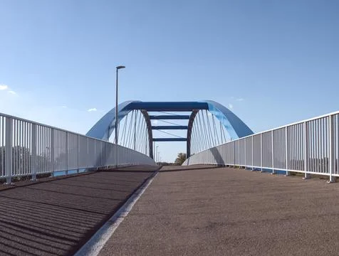 Frog perspective of blue bridge separating pedestrian traffic Фото