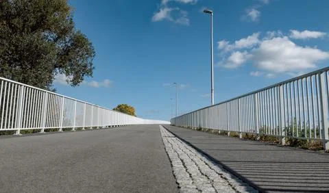 Frog perspective of road separating pedestrian and bicycle traffic Stock Photos