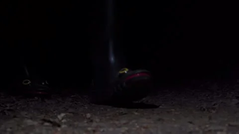 Frog-Shaped Rain Boot Sole And Toe Detail On Dark Ground At Night, Close Up Shot Video stock 337899147