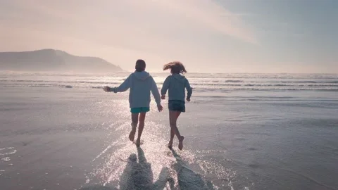 Frolicking in the shallows on a beautiful beach Stock-Footage 132142053