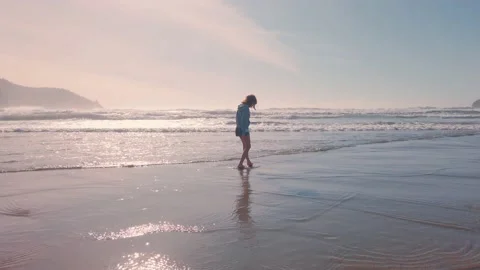 Frolicking in the shallows on a beautiful beach Stock Footage 132142328