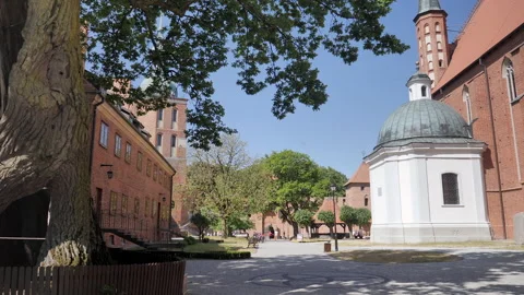 FROMBORK, POLAND - SEPTEMBER 9 2023: Square next to cathedral and bell tower. Stock Footage 268585124