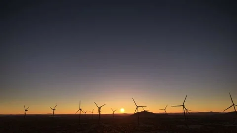 Front aerial shot at sunset of wind turbine renewable energy wind farms Stock Footage 204847170