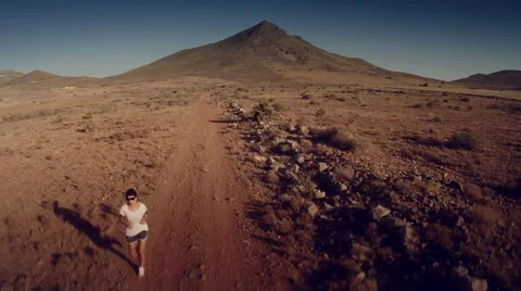 Front aerial view of a runner at desert. Spain. 4K Stock Footage 52441645