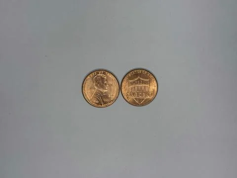 Front and Back of U.S. One Cent Penny Coins on Neutral Background Foto stock