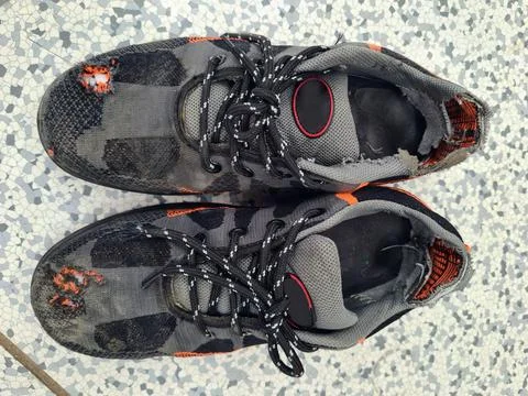 Front and inside Damaged or Torn safety shoes top view no people old type. Stock Photos