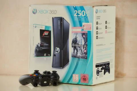A front and side view of the box of used XBOX 360 250GB Console and one gamepad Stock Photos