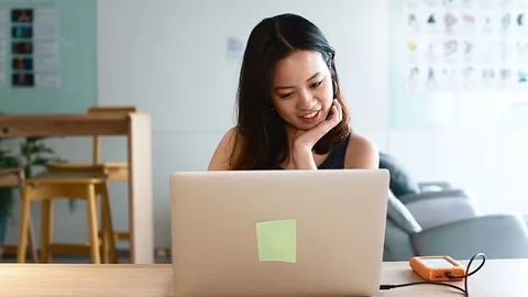 Front angle - asian thinks on laptop Stock Footage 75196088