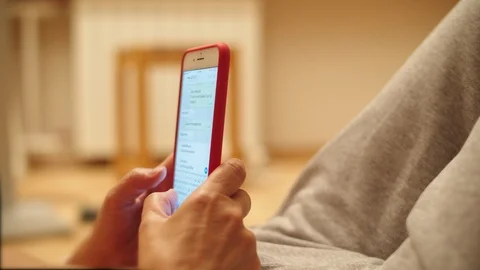 Front angle close up shot of a female scrolling and typing on his phone outside. Stock Footage 111407356
