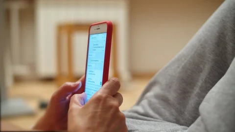 Front angle close up shot of a female scrolling and typing on his phone outside. Video stock 111408371