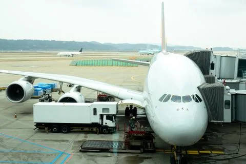 Front angle view of airplane on gate terminal preparing for take off. Stock Photos