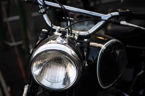 Front angle view of classic black motorcycle with shiny chrome headlight an.. Stock Photos