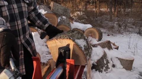 Front angle view of log splitter in action with snow in background Stock Footage 1008928