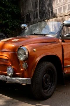 Front Angle View of Vintage Brown Convertible Car on Asphalt Road Stock Photos