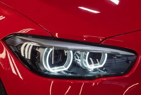 Front BI-LED headlight on a red sport car. Stock Photos