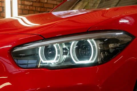 Front BI-LED headlight on a red sport car. Stock Photos