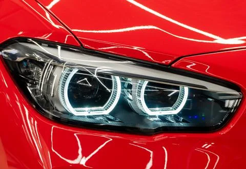 Front BI-LED headlight on a red sport car. Stock Photos