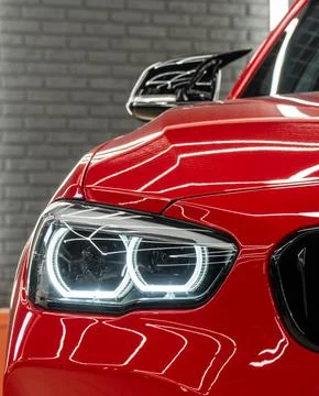 Front BI-LED headlight on a red sport car. Stock Photos