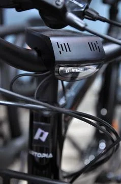 Front bicycle light and cables on urban electric bike Stock Photos