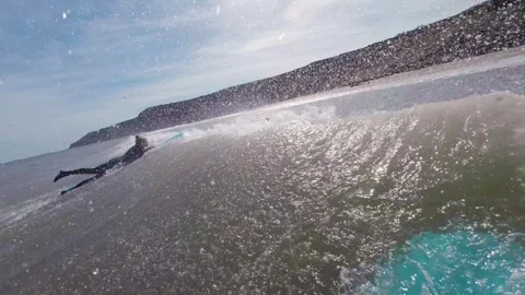 Front of blue surf board moving through wave towards surfer Stock Footage 272589850