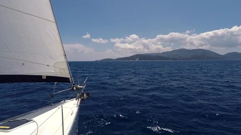Front bow of a sailboat open sails in the calm sea Stock Footage 112604221