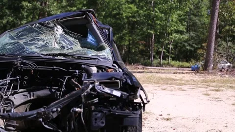 Front of a Broken Black Car in a Junkyard Stock Footage 246715927